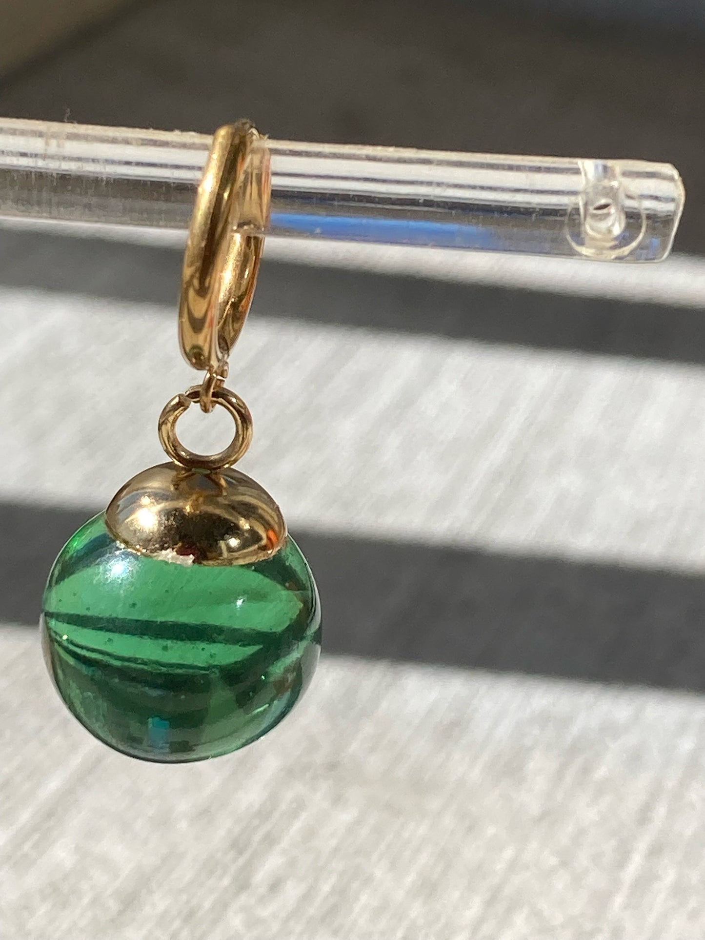 Green Potara fusion earrings with gold accents for anime fans