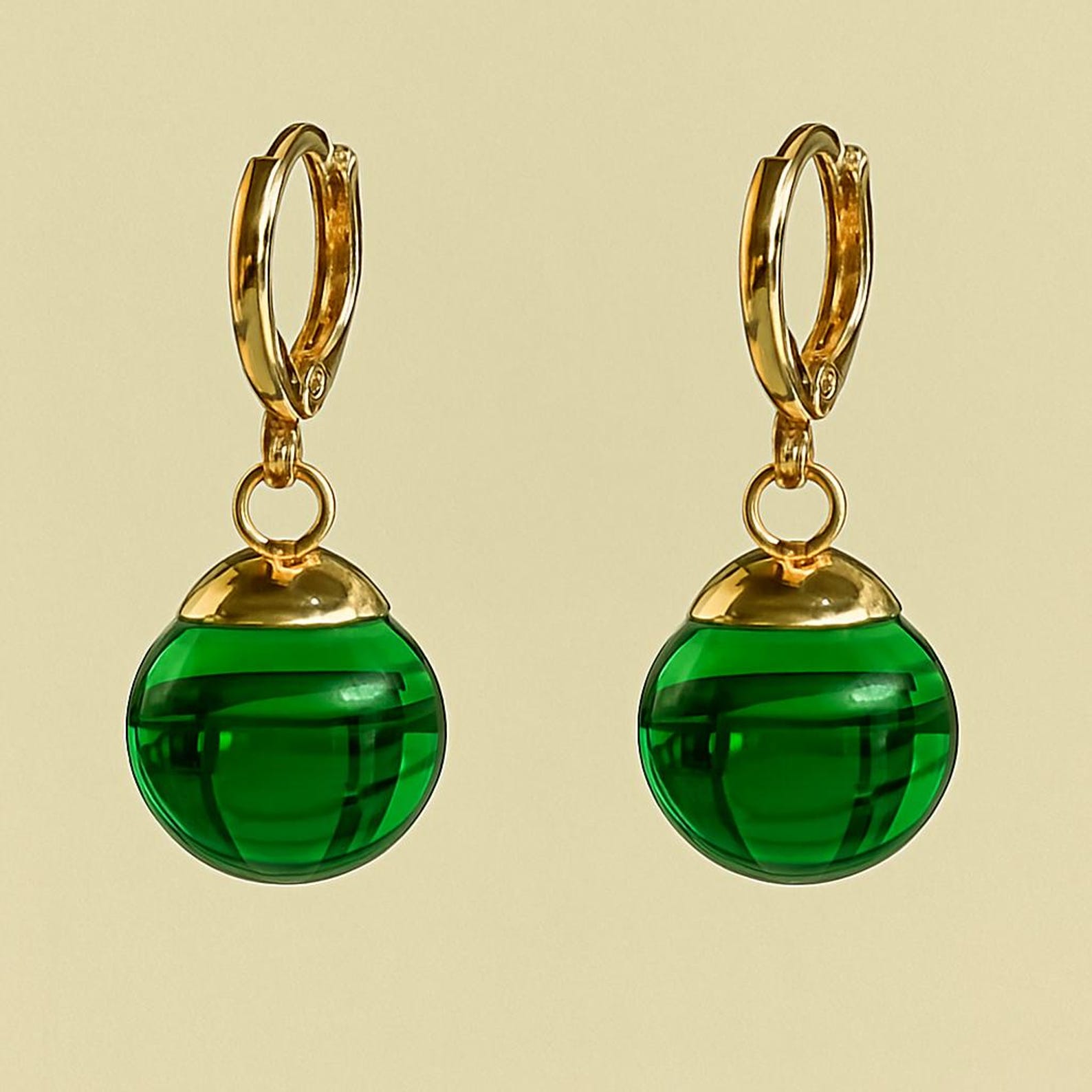 Green Potara fusion earrings with gold accents for anime fans