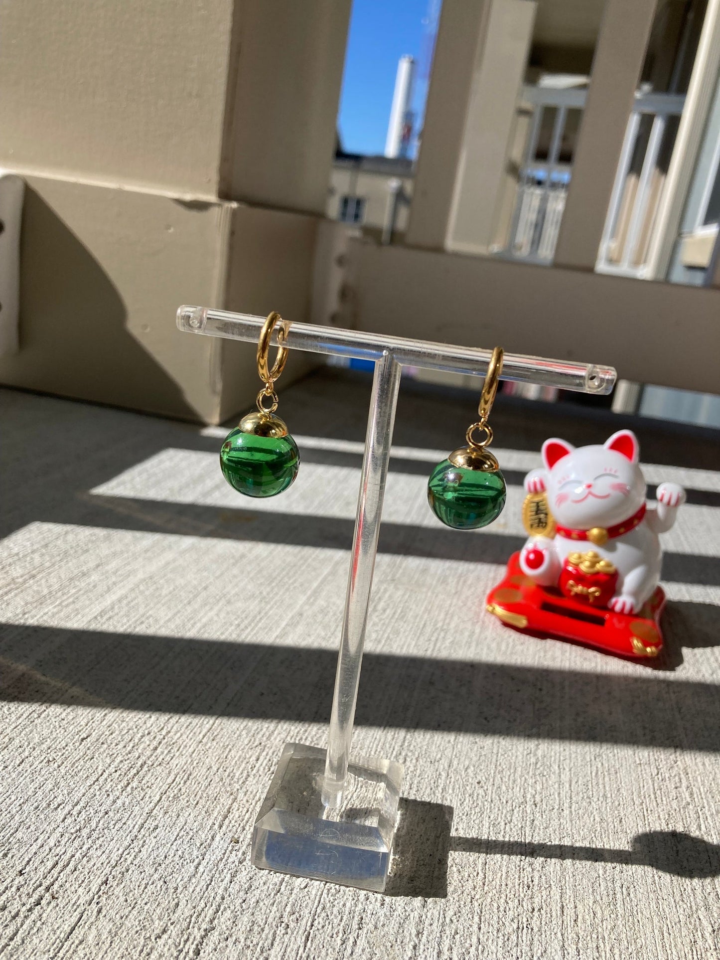 Green Potara fusion earrings with gold accents for anime fans