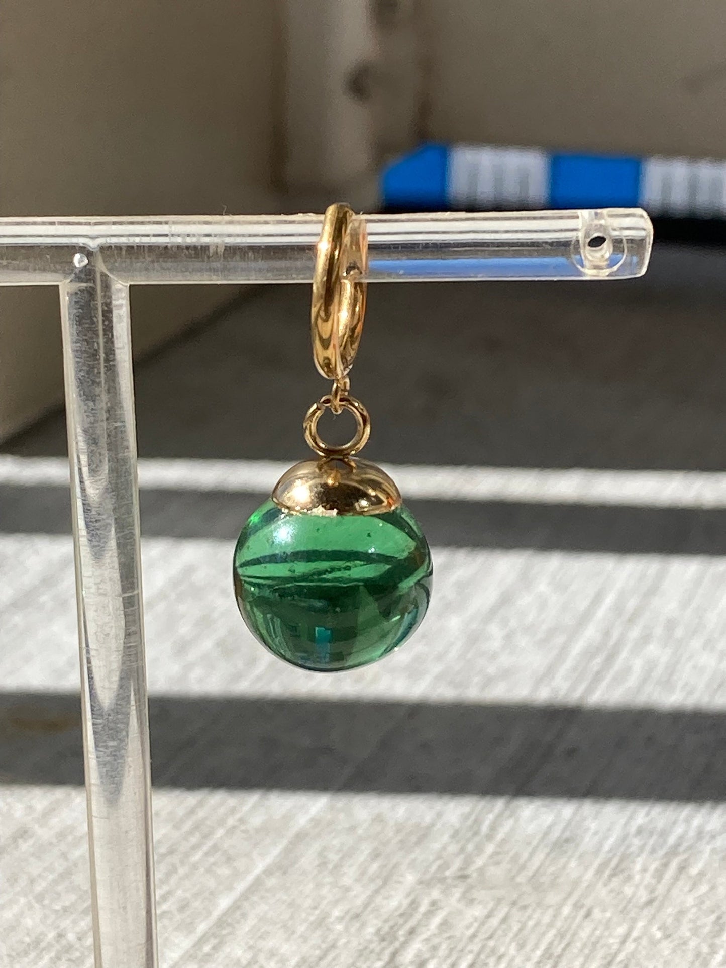 Green Potara fusion earrings with gold accents for anime fans